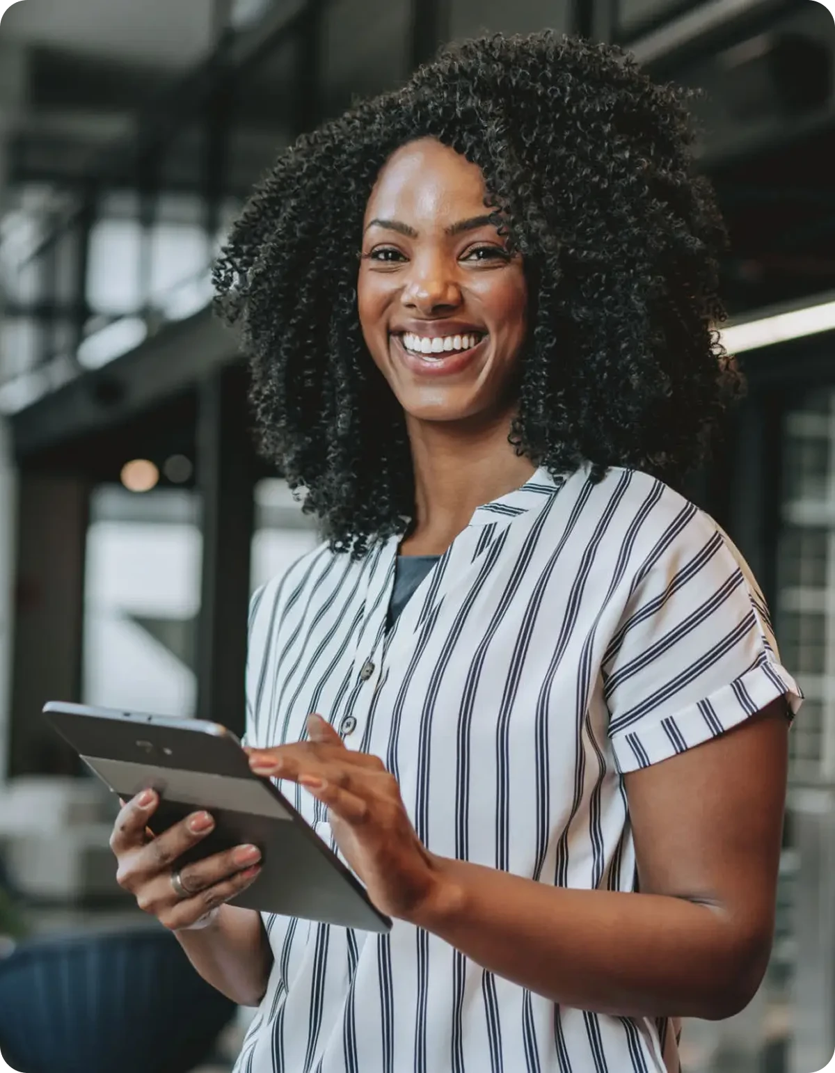 Smiling woman holding a digital tablet.