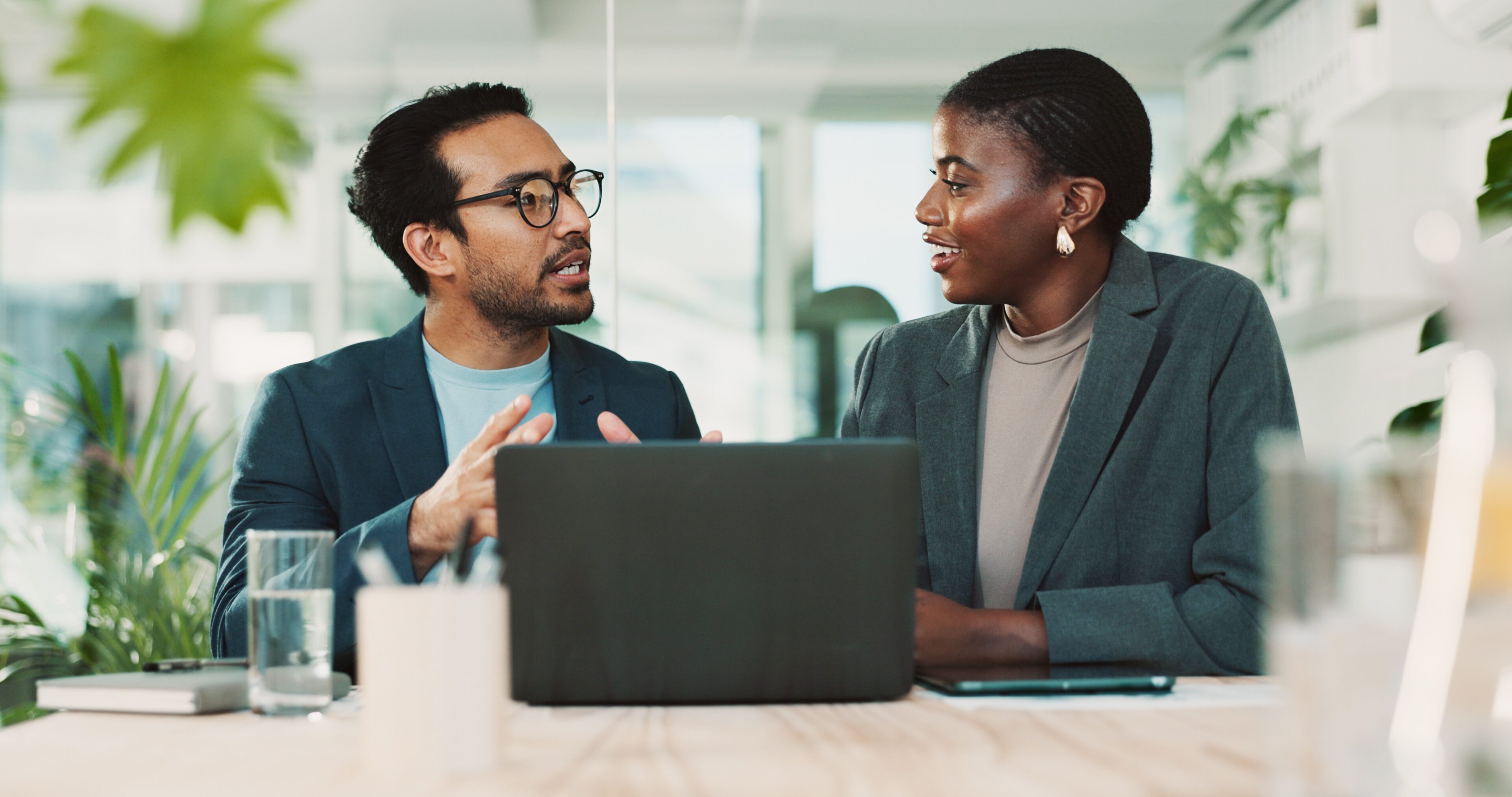 Two colleagues discussing in an office.