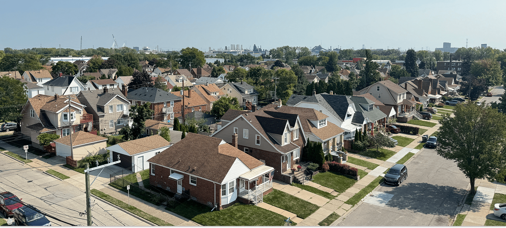 Suburban neighborhood with houses and tree-lined streets.